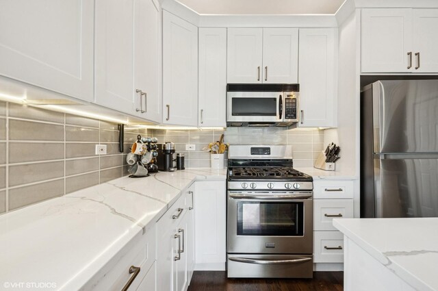 1444 N Bosworth Ave Unit 3S, Chicago, IL 60642 - kitchen with stainless steel appliances, white cabinets, backsplash, and light stone counters