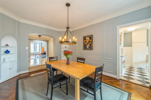 421 W Melrose St Unit 10B, Chicago, IL 60657 - dining space with a decorative wall, ornamental molding, arched walkways, a chandelier, and built in shelves