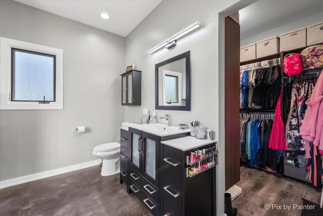 3609 Sagebrush Ct, Johnsburg, IL 60051 - bathroom featuring vanity, toilet, baseboards, a spacious closet, and recessed lighting