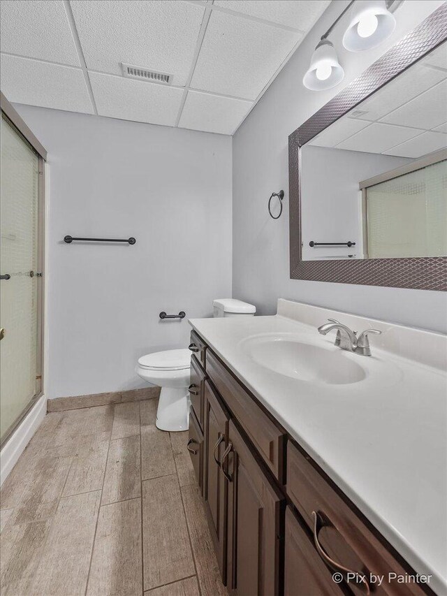 3609 Sagebrush Ct, Johnsburg, IL 60051 - bathroom with vanity, a drop ceiling, toilet, a shower stall, and wood finished floors