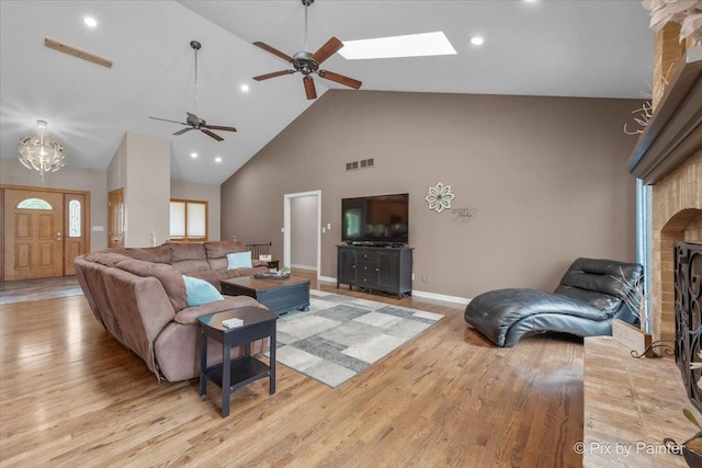 3609 Sagebrush Ct, Johnsburg, IL 60051 - living area with high vaulted ceiling, light wood finished floors, ceiling fan, baseboards, and a brick fireplace