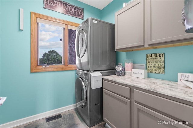 3609 Sagebrush Ct, Johnsburg, IL 60051 - laundry room with estacked washer and dryer, cabinet space, and baseboards