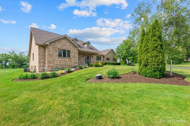 3609 Sagebrush Ct, Johnsburg, IL 60051 - view of front facade with brick siding, a front lawn, and central AC