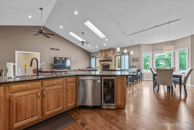 3609 Sagebrush Ct, Johnsburg, IL 60051 - kitchen featuring stainless steel dishwasher, wine cooler, a sink, a ceiling fan, and dark wood-type flooring