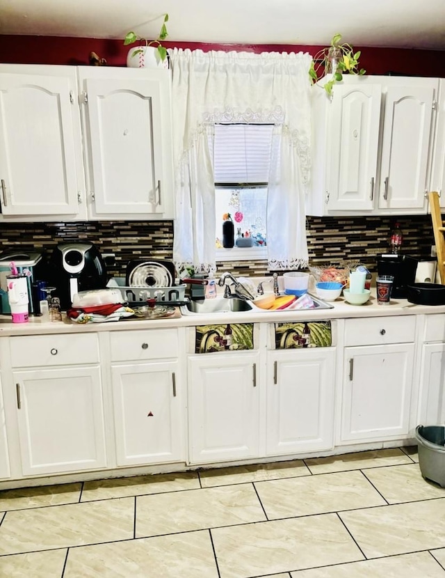 332 N Ave, Aurora, IL 60505 - kitchen with white cabinets, decorative backsplash, light countertops, and light tile patterned floors