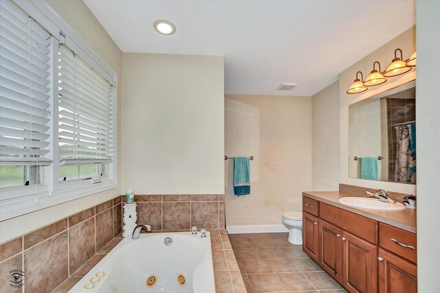 942 Meadowbrook Rd, Elwood, IL 60421 - bathroom with a jetted tub, vanity, toilet, baseboards, and tile patterned flooring