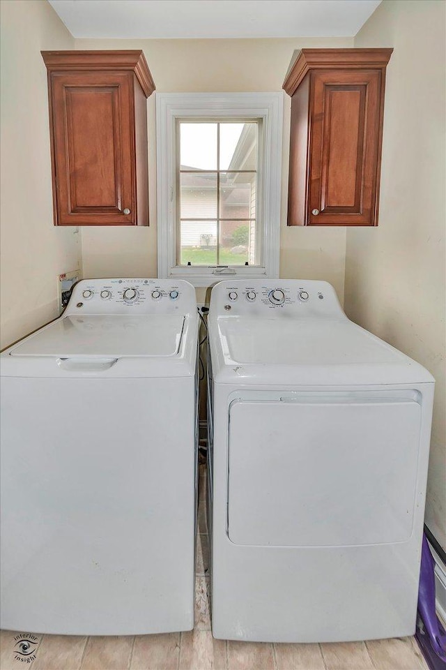 942 Meadowbrook Rd, Elwood, IL 60421 - laundry area featuring washing machine and clothes dryer and cabinet space