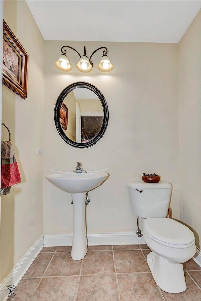 942 Meadowbrook Rd, Elwood, IL 60421 - half bath featuring toilet, baseboards, and tile patterned floors
