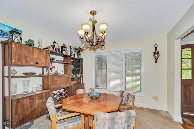 942 Meadowbrook Rd, Elwood, IL 60421 - dining area featuring a chandelier, baseboards, and light colored carpet