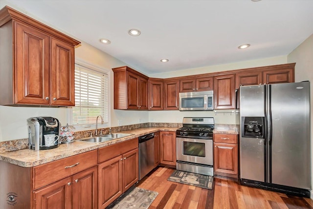 942 Meadowbrook Rd, Elwood, IL 60421 - kitchen featuring stainless steel appliances, a sink, light wood finished floors, recessed lighting, and brown cabinets