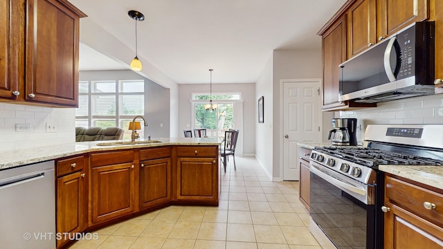 2217 Tyler Trl, Mchenry, IL 60051 - kitchen with appliances with stainless steel finishes, a sink, brown cabinetry, and decorative backsplash