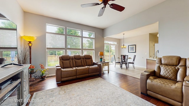 2217 Tyler Trl, Mchenry, IL 60051 - living room with dark wood-style flooring, a ceiling fan, baseboards, and a chandelier