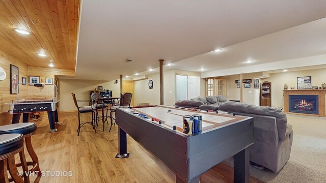 2217 Tyler Trl, Mchenry, IL 60051 - playroom with light wood-style flooring, recessed lighting, a lit fireplace, wood ceiling, and wood walls