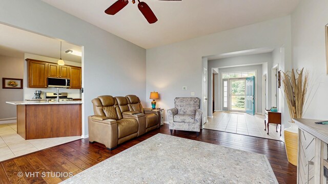 2217 Tyler Trl, Mchenry, IL 60051 - living room featuring ceiling fan, light wood-style flooring, and baseboards