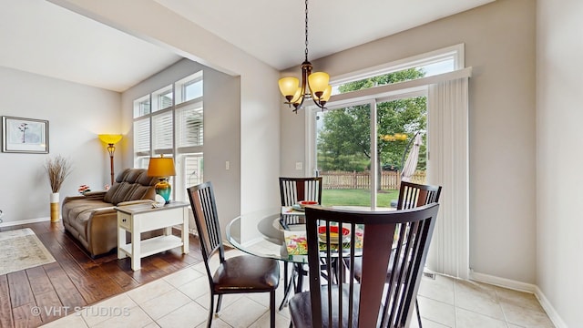 2217 Tyler Trl, Mchenry, IL 60051 - dining room with healthy amount of natural light, a chandelier, light tile patterned floors, and baseboards