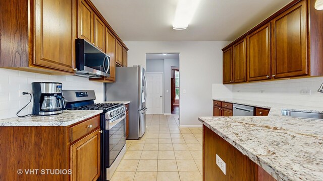 2217 Tyler Trl, Mchenry, IL 60051 - kitchen featuring appliances with stainless steel finishes, a sink, decorative backsplash, and light tile patterned floors