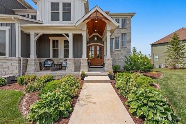 1044 Redbud Ln, Sugar Grove, IL 60554 - property entrance with board and batten siding, stone siding, and covered porch
