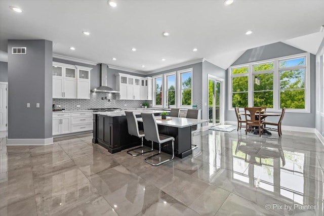 1044 Redbud Ln, Sugar Grove, IL 60554 - kitchen with wall chimney exhaust hood, light countertops, tasteful backsplash, a spacious island, and white cabinets
