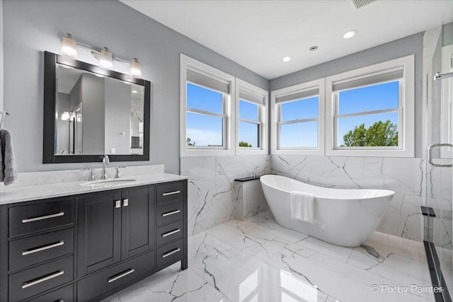 1044 Redbud Ln, Sugar Grove, IL 60554 - full bathroom featuring tile walls, marble finish floors, a freestanding tub, vanity, and recessed lighting