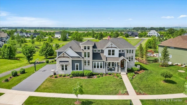 1044 Redbud Ln, Sugar Grove, IL 60554 - view of front of home featuring stone siding, a front yard, and a residential view