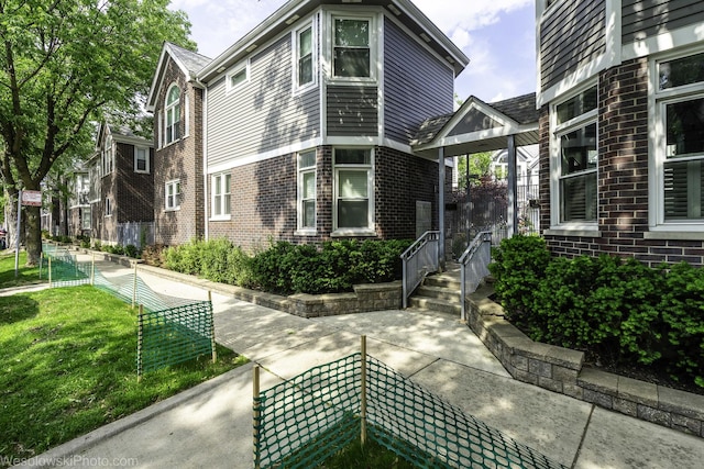 3315 N Racine Ave Unit E, Chicago, IL 60657 - view of front facade featuring brick siding and a front lawn