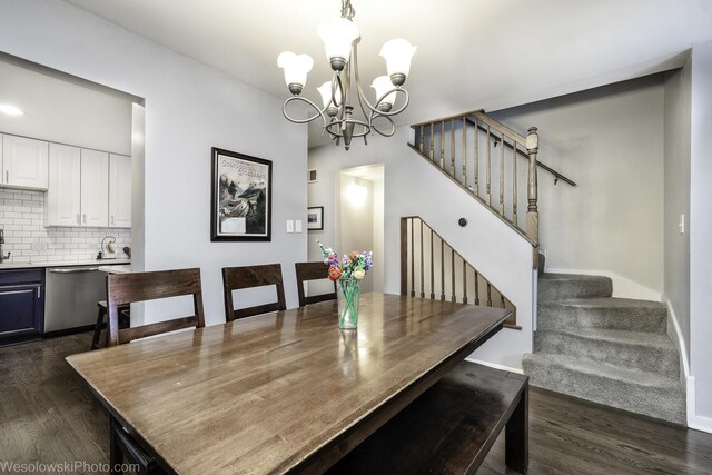 3315 N Racine Ave Unit E, Chicago, IL 60657 - dining room with dark wood finished floors, a chandelier, and stairs
