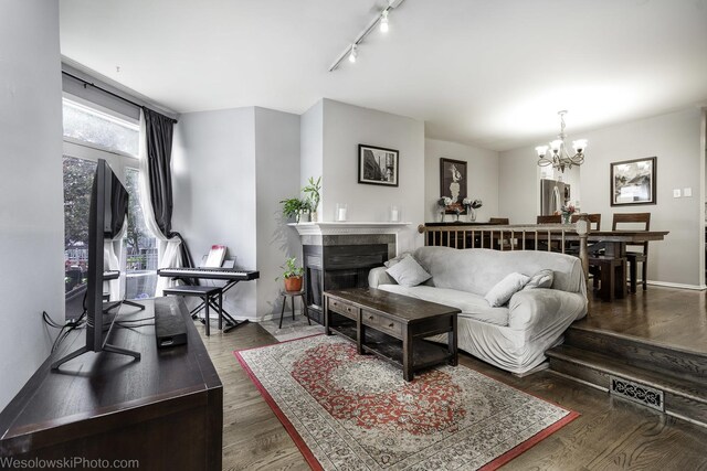 3315 N Racine Ave Unit E, Chicago, IL 60657 - living room with a chandelier, a fireplace, wood finished floors, and rail lighting