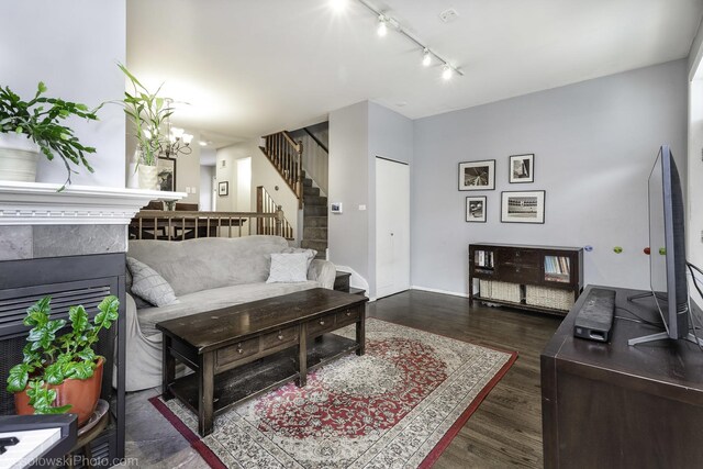 3315 N Racine Ave Unit E, Chicago, IL 60657 - living room with track lighting, stairway, dark wood finished floors, a chandelier, and a tiled fireplace