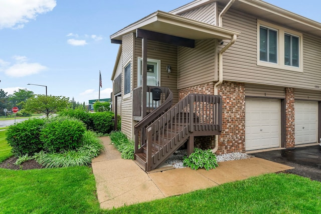 1355 Kingsbury Dr Unit 1, Hanover Park, IL 60133 - view of front of house with brick siding, a garage, and driveway