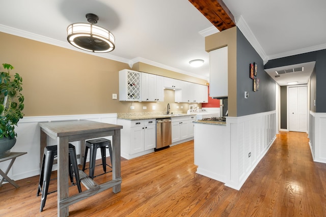 1355 Kingsbury Dr Unit 1, Hanover Park, IL 60133 - kitchen featuring stainless steel dishwasher, crown molding, white cabinets, light wood-style floors, and a wainscoted wall
