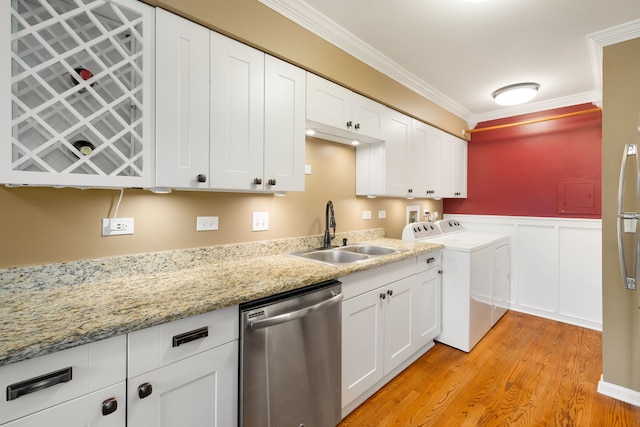 1355 Kingsbury Dr Unit 1, Hanover Park, IL 60133 - kitchen featuring dishwasher, a sink, washer and dryer, light wood-style flooring, and white cabinets