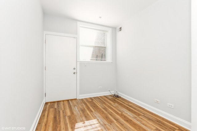 7363 N Damen Ave Unit 302, Chicago, IL 60645 - spare room featuring baseboards and light wood-type flooring