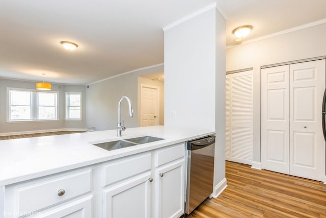 7363 N Damen Ave Unit 302, Chicago, IL 60645 - kitchen with stainless steel dishwasher, a sink, crown molding, light countertops, and light wood finished floors