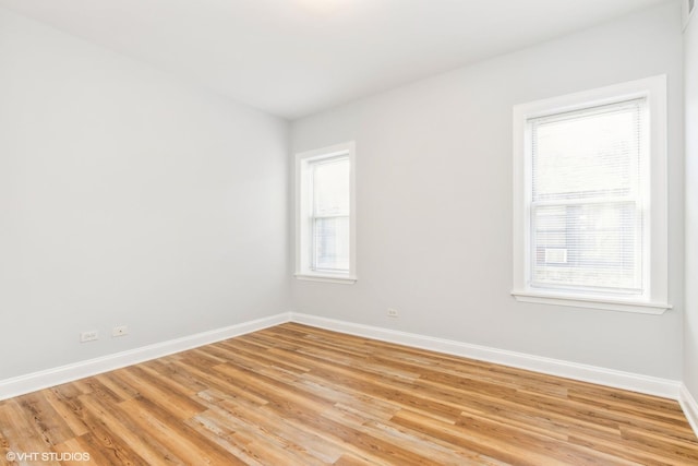 7363 N Damen Ave Unit 302, Chicago, IL 60645 - empty room featuring baseboards and light wood-style floors