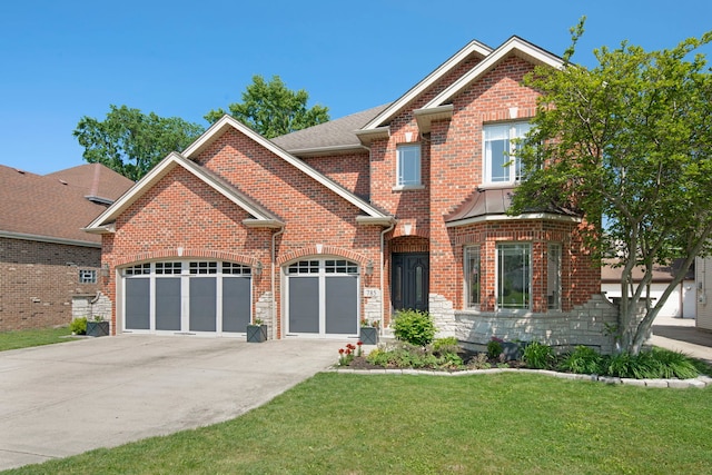 785 N Emroy Ave, Elmhurst, IL 60126 - view of front of home with an attached garage, concrete driveway, a front yard, and brick siding