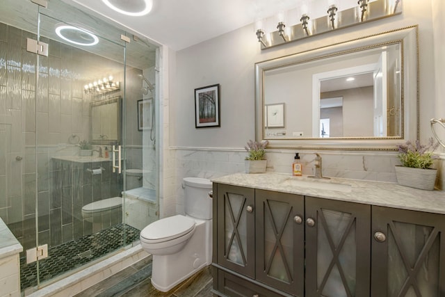 785 N Emroy Ave, Elmhurst, IL 60126 - bathroom with toilet, vanity, a shower stall, tile walls, and wood finished floors