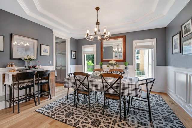 785 N Emroy Ave, Elmhurst, IL 60126 - dining space featuring a raised ceiling, a chandelier, light wood-style floors, a wainscoted wall, and crown molding
