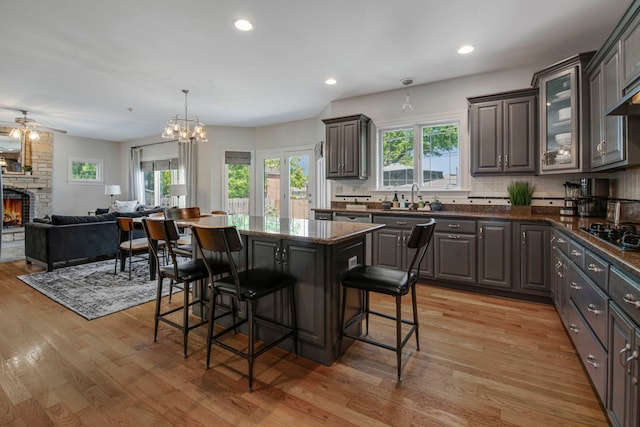 785 N Emroy Ave, Elmhurst, IL 60126 - kitchen featuring a sink, a breakfast bar, light wood finished floors, decorative backsplash, and recessed lighting