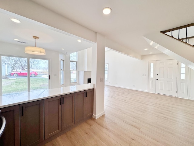 2326 Hamilton Pl Unit 2326, Schaumburg, IL 60194 - kitchen featuring light wood-type flooring, light countertops, decorative light fixtures, open floor plan, and recessed lighting