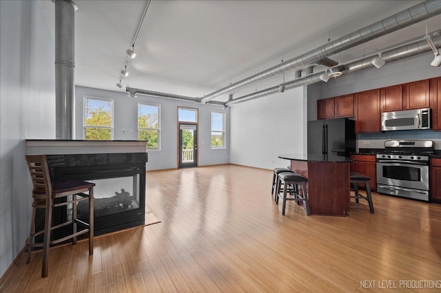 1673 Town Center St Unit 1673, Aurora, IL 60504 - kitchen featuring appliances with stainless steel finishes, track lighting, plenty of natural light, and a breakfast bar