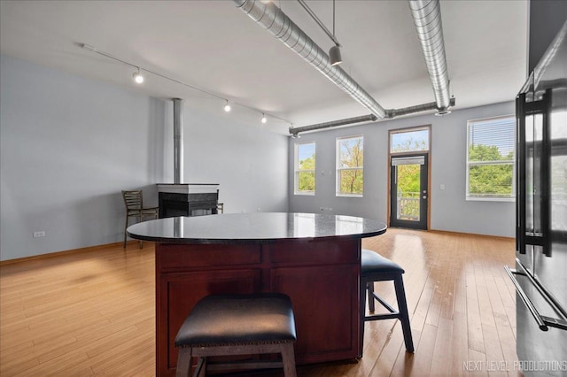 1673 Town Center St Unit 1673, Aurora, IL 60504 - kitchen with refrigerator, light wood-type flooring, open floor plan, a breakfast bar, and a center island