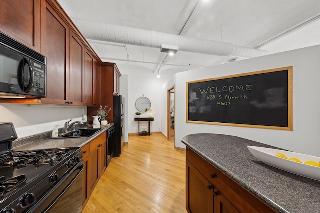 633 S Plymouth Ct Unit 607, Chicago, IL 60605 - kitchen featuring black appliances, a sink, light wood-style floors, dark countertops, and baseboards