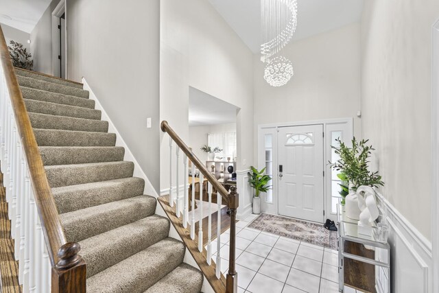 5225 Nicholas Ct, Oak Forest, IL 60452 - entryway featuring a towering ceiling, stairway, light tile patterned flooring, and a chandelier
