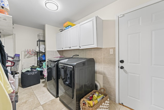 5225 Nicholas Ct, Oak Forest, IL 60452 - laundry area featuring washing machine and dryer, cabinet space, light tile patterned flooring, and tile walls