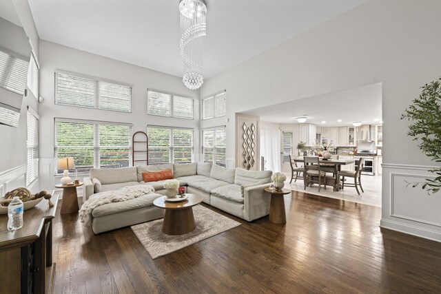5225 Nicholas Ct, Oak Forest, IL 60452 - living room with a high ceiling, dark wood finished floors, a chandelier, wainscoting, and a decorative wall