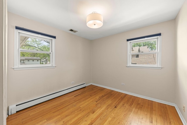 4520 Prince St, Downers Grove, IL 60515 - spare room with a baseboard radiator, light wood-type flooring, and baseboards