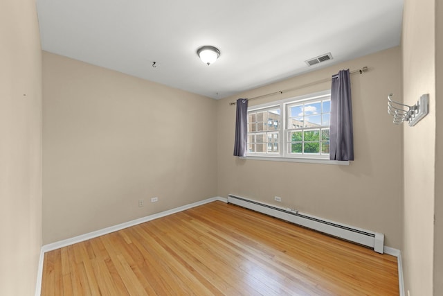 4520 Prince St, Downers Grove, IL 60515 - spare room featuring a baseboard heating unit, wood finished floors, and baseboards