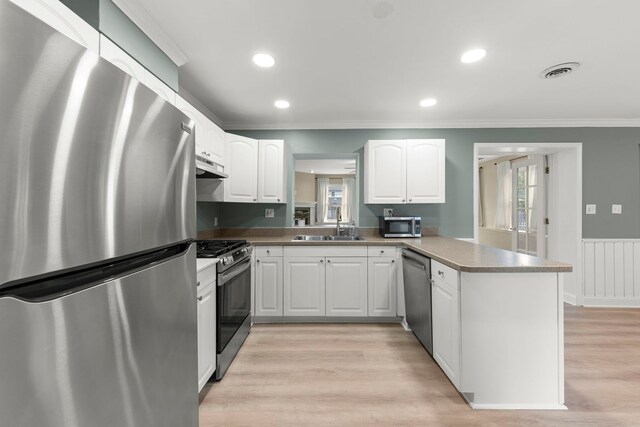 4520 Prince St, Downers Grove, IL 60515 - kitchen featuring appliances with stainless steel finishes, under cabinet range hood, ornamental molding, a peninsula, and healthy amount of natural light
