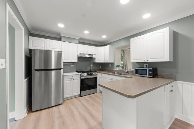 4520 Prince St, Downers Grove, IL 60515 - kitchen with appliances with stainless steel finishes, a sink, under cabinet range hood, white cabinets, and crown molding