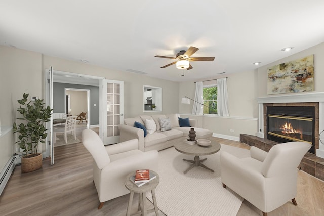4520 Prince St, Downers Grove, IL 60515 - living area featuring wood finished floors, a tile fireplace, a baseboard heating unit, and a ceiling fan